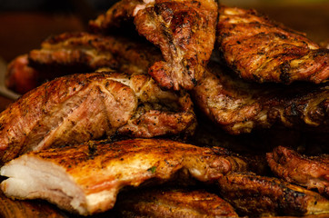 Roasted sliced barbecue pork ribs, focus on sliced meat