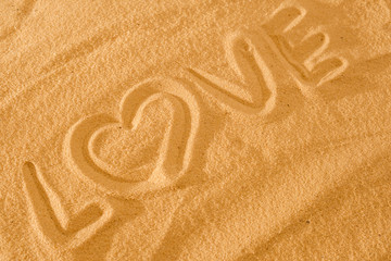 Heart in the sand on the beach. Love symboll with text