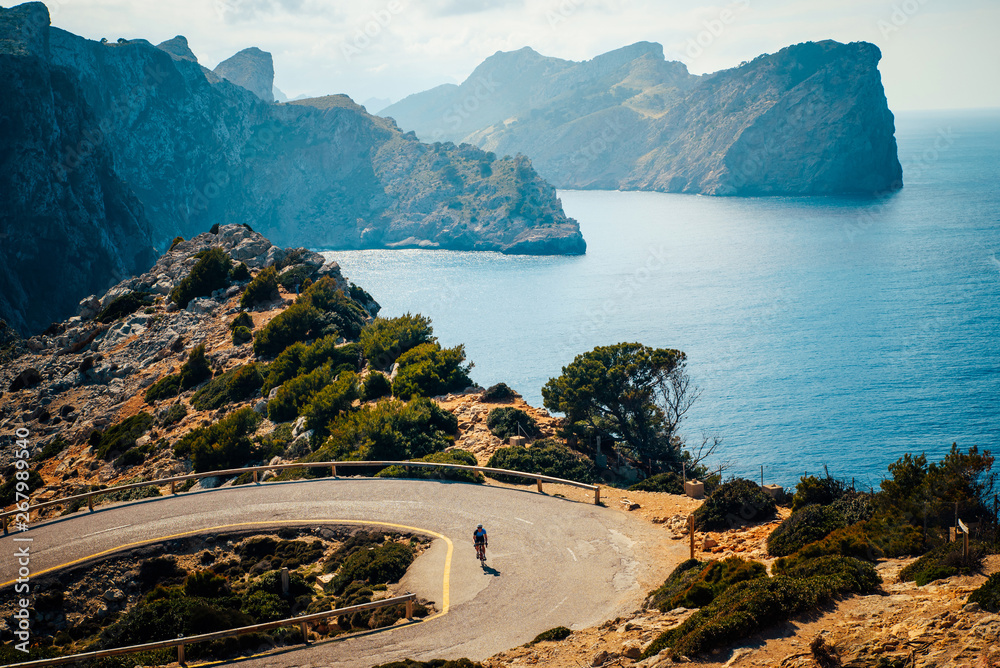 Wall mural road bikers on the road on balearic islands. sea in background. cap de formentor. mallorca, majorca,