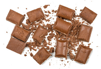 Chocolate pieces on white background, top view
