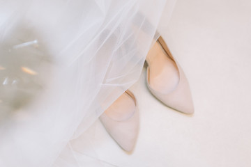 beautiful white wedding shoes of the bride.