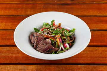 Top-view salad with medium rare beef steak