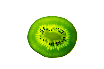 close up view of an isolated and backlit green kiwi fruit slice on a bright white background with...