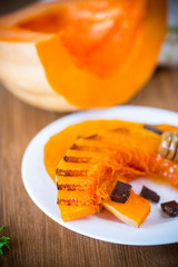 grilled sweet ripe pumpkin, in a plate with honey
