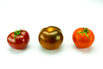 tasty colorful organic tomatoes of different types isolated on a white background with copy space