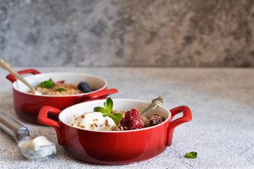 Berry crumble with nuts and ice cream on the kitchen table.