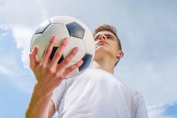 Happiness football player with ball and blue sky