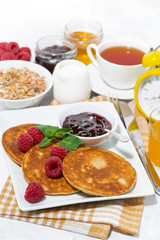 delicious pancakes with fresh raspberries and jam for breakfast, vertical