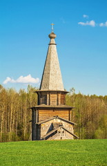 Old rural log church in style of  northern regions of Russia