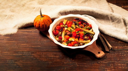 Grilled vegetables in ceramic bowl on wooden background.The concept of healthy eating.