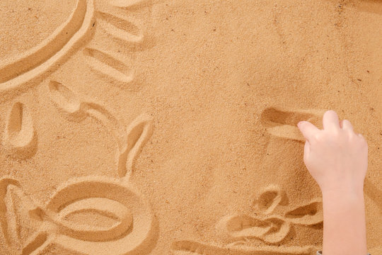 Sand therapy, child's hands are painted on table with sand