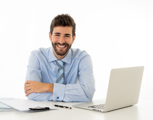 Attractive happy Young caucasian businessman working on laptop computer feeling successful at work