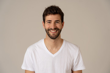 Portrait of attractive cheerful young man with smiling happy face. Human expressions and emotions