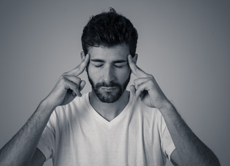 Portrait of sad man in pain having headache and migraines