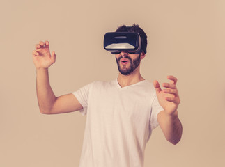 Fototapeta premium Portrait of excited and amazed young man wearing Virtual Reality headset exploring 3D world