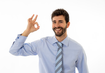 Portrait of young attractive businessman smiling and doing all OK sign Isolated on white background