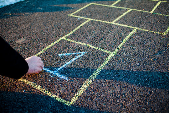 A young man draws hopscotch on asphalt. Good mood and spring in Russia. A bearded man recalls his childhood.