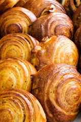 Close-up of baked sweet foods. Bun with cream