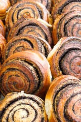 Close-up of baked sweet foods. Bun with poppy seeds