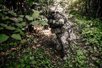 Armed intelligence of the United States of America are in the woods scouting the situation aiming...