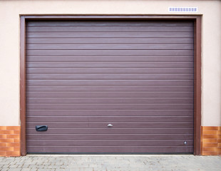 The entrance to the garage is equipped with a roller shutter gate.