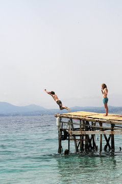 kids on holiday jumping into the sea