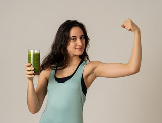 Beautiful fit sport latin woman drinking healthy fresh vegetable smoothie feeling great and healthy