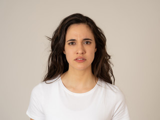 Portrait of beautiful young latin woman with angry and furious face. Human expressions and emotions
