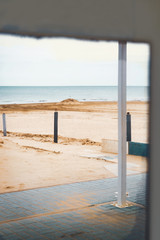 Old mirror reflects the beach, outdoors