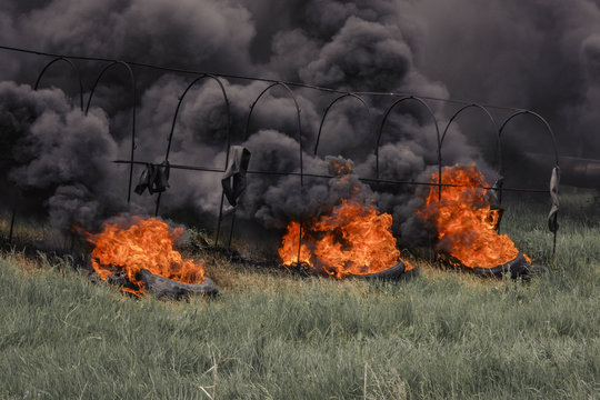 fire barriers for fire departments burning tires smoky sky