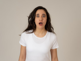 Young excited woman shocked and happy looking at unbelievable sales or surprise with overjoy