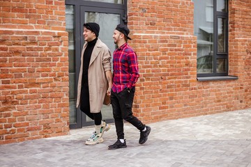 Fototapeta na wymiar Two homosexuals walking down the street holding hands