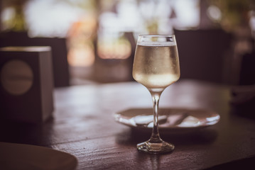 Glass of white wine on table in a restaurant