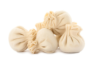 Heap of raw dumplings with tasty filling on white background