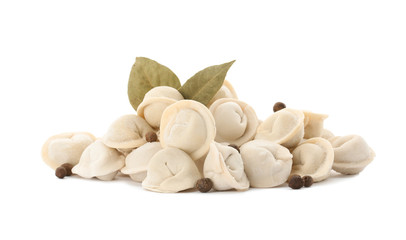 Raw meat dumplings with bay leaves on white background