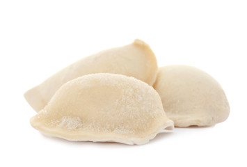 Raw dumplings with tasty filling on white background