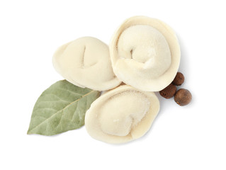 Raw dumplings with bay leaf and pepper on white background, top view