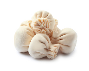 Pile of raw dumplings on white background