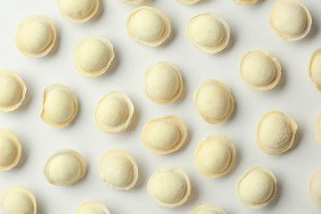 Composition with raw dumplings on white background, top view