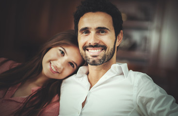 Young couple on the sofa in love