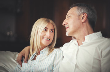  Senior Couple Relaxing On Sofa At Home