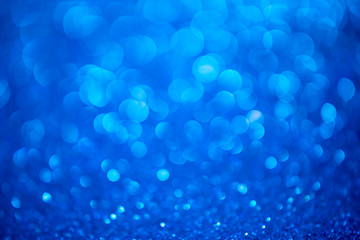 Blue glitter christmas abstract background. Defocused sequin light.