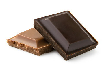 Square of dark chocolate resting on a square of milk chocolate isolated on white. Rough edges.