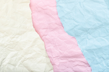 Background of scraps of white, pink and blue crumpled paper