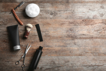 Flat lay composition with men's cosmetic products on wooden background. Space for design