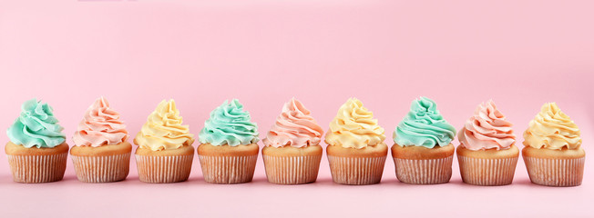 Row of delicious cupcakes on color background, space for text - Powered by Adobe