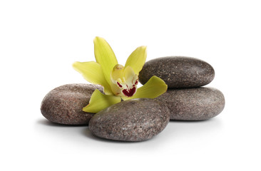 Spa stones with beautiful orchid flower on white background