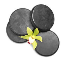Obraz na płótnie Canvas Beautiful orchid flower and spa stones on white background, top view