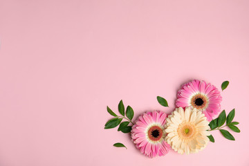 Flat lay composition with beautiful bright gerbera flowers on color background. Space for text