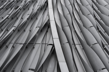 Vertical bend gray aluminium modular facade  with gap in repeat pattern / architectural texture /...